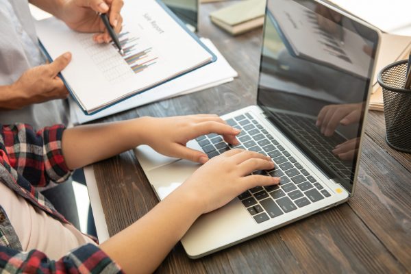 Business woman typing on laptop at workplace Woman working in office hand keyboard.teamwork process.business people discussing the charts and graphs showing the results they are successful cooperation