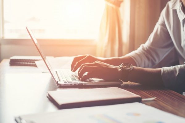 close-up-male-hands-using-laptop-home_1150-790