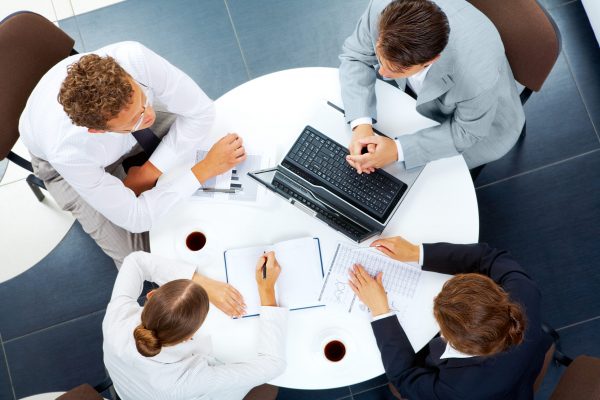 Above view of several business people planning work at round table