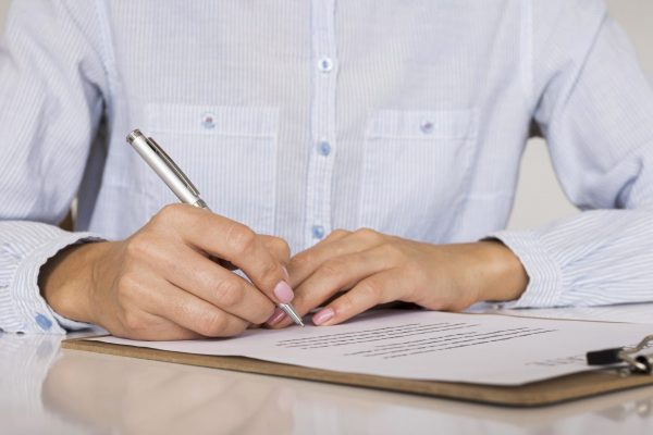 person-signing-a-contract-or-a-certificate