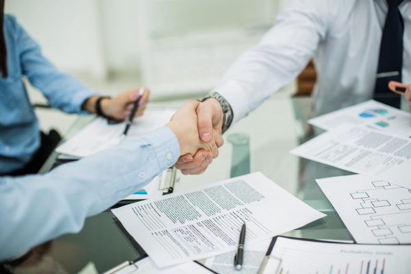 reliable handshake business partners after signing new contract in the workplace in the office.the photo has a empty space for your text
