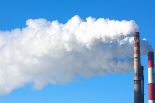 White smoke comes from pipes against blue sky. Problem harmful emissions and air pollution of central heating population of large cities eco concept